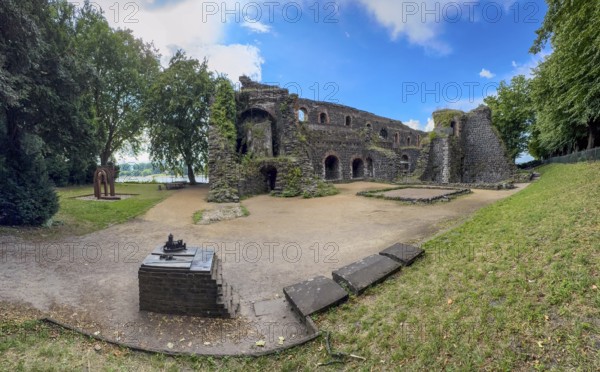Panoramic photo of the ruins of the imperial palace of Emperor Frederick I Barbarossa, built in the Middle Ages around 1184 on the left in the background of today's banks of the Rhine, in the foreground small model of the original fortress building, Kaiserswerth, Düsseldorf, North Rhine-Westphalia, Germany