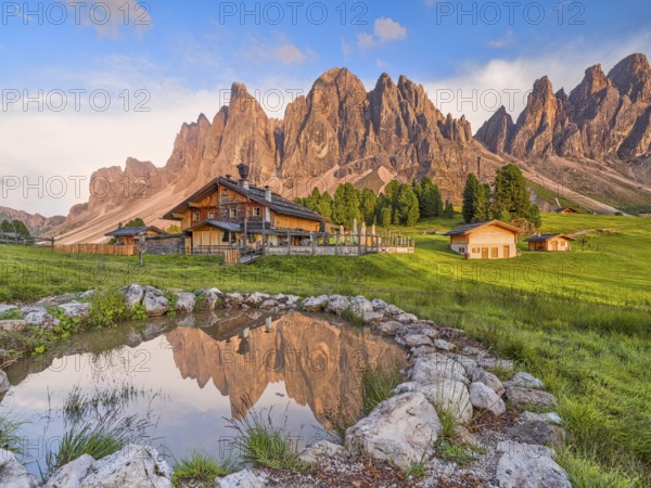 Geisleralm with Geisler group and alpenglow, reflection, Dolomites, Santa Magdalena, South Tyrol, Italy