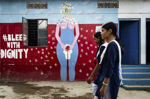 Students walk past a mural about female menstruation at Parijat Academy on the eve of Menstrual Hygiene Day, in Guwahati, India on May 27, 2025. Menstrual Hygiene Day, observed on May 28, is a global initiative to raise awareness about the importance of good menstrual hygiene for women
