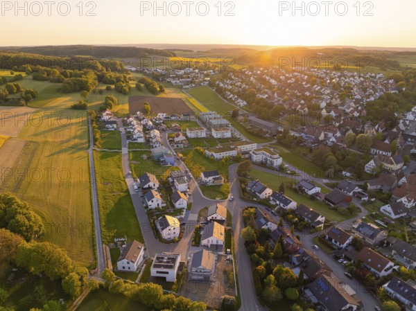 Aerial view of a rural village with houses and wide fields at sunset, Gechingen, Black Forest, Germany