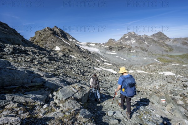 Mountaineer in rocky mountain landscape, hike between Col de Plafleuri and Col du Louvie, Valais Alps, Val de Bagnes, Valais, Switzerland