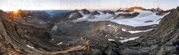 Panorama at sunrise with sun star, high mountain landscape, view of blue glacial lakes, mountain peaks Königshofspitz and Hofmannspitze with glacier of the Übeltalferner, Stubai Alps, South Tyrol, Italy