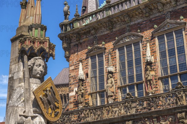 Roland statue on the market square in front of the town hall, symbol of medieval urban market law, shield with imperial eagle of the Holy Roman Empire, sword, historic city centre, Hanseatic city of Bremen, Germany