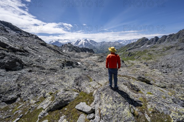 Mountaineer in rocky mountain landscape at the Col du Louvie, view of the summit of the Grand Combine, Valais Alps, Val de Bagnes, Valais, Switzerland