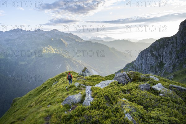 Mountaineers in a picturesque mountain landscape in the atmospheric evening light, view from the Cabane du Louvie, Valais Alps, Val de Bagnes, Valais, Switzerland