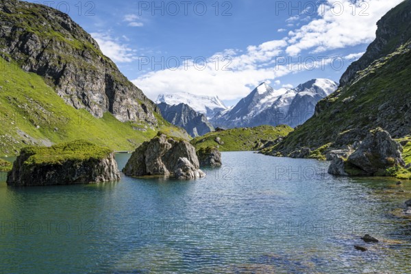 Mountain lake with view of glaciated mountain peaks, Lac du Louvie with summit Grand Combine, Valais Alps, Val de Bagnes, Valais, Switzerland