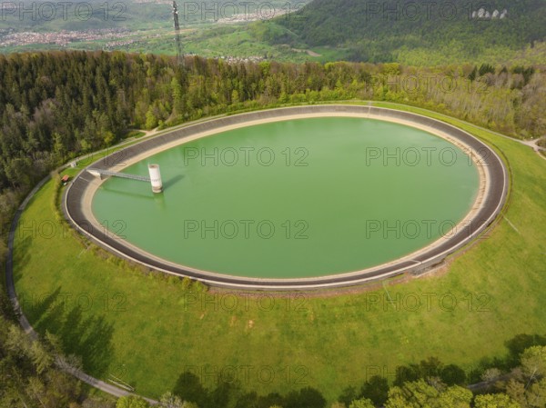 Upper reservoir, circular reservoir embedded in forest and hilly landscape, Glems reservoir, Swabian Alb, Germany