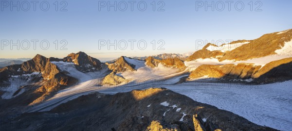 Picturesque high mountain landscape at sunrise with alpenglow, glacier and rocky mountain peaks in the morning light, view at Becher of mountain peaks Königshofspitz and Sonklarspitze and Schwarzwandspitz with glacier Übeltalferner, Stubai Alps, South Tyrol, Italy