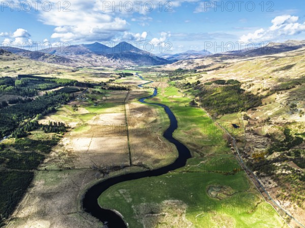 Farms and Mountains over River Dochart and Road A85 from a drone, Perthshire, Scotland, UK