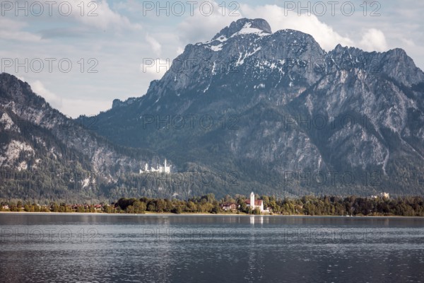 A lake against an impressive mountain backdrop with Neuschwanstein Castle in the background, Schwangau, Bavaria