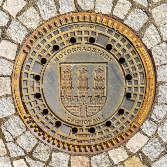 Manhole cover with the coat of arms of the motorbike town of Zschopau, Erzgebirge, Saxony, Germany