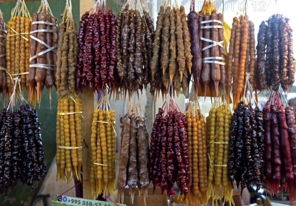 Traditional Georgian sweets Churchkhela made from walnuts and thickened grape juice, market stall in Kutaisi, Georgia