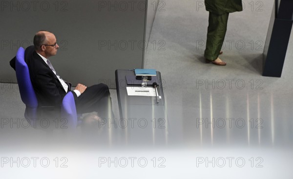 Federal Chancellor Friedrich Merz (CDU) and parts of his cabinet sit on the government bench, whilec, co-chair of the Greens parliamentary group, responds to the Federal Chancellor's government statement