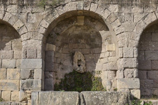 Ancient round arches with a sculpture and moss growth, arcade, lower terrace, Pan, Asklipion, Asklepieion, healing temple, temple, Hippocrates, Kos, Dodecanese, Greek Islands, Greece
