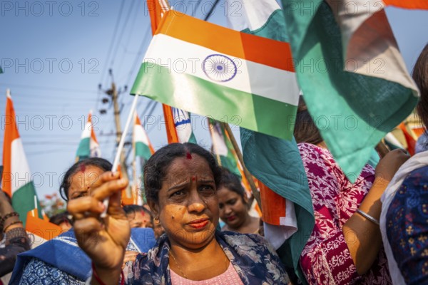 People holding Indian national flags as they take part in a rally, in soliderity with the Indian armed forces in Guwahati, India on 14 May 2025. A nationwide campaign Tiranga Yatra organized by the Bharatiya Janata Party (BJP) to honor the Indian armed forces' success in Operation Sindoor