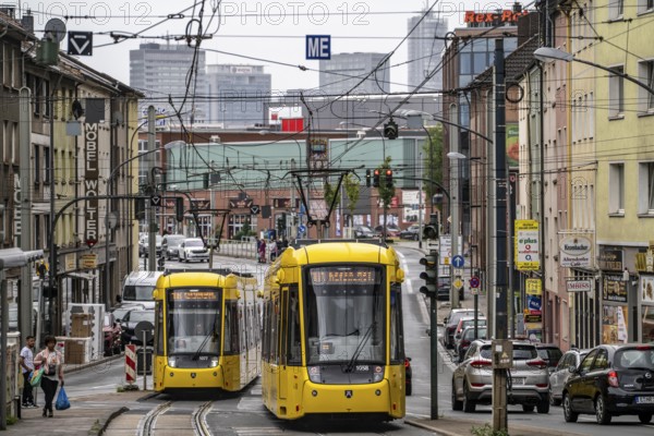 Ruhrbahn tram, on Altendorfer Straße, intersection Helenenstraße, in Essen-Altendorf, rush hour, traffic, skyline of the city centre of Essen, North Rhine-Westphalia, Germany