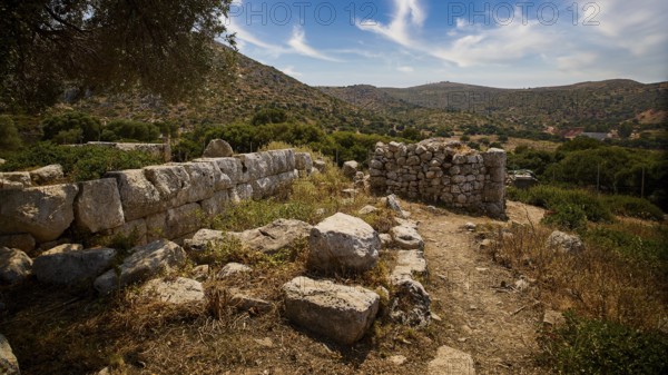 Heaven exchanged, ancient ruins in a hilly landscape with a clear blue sky and scattered clouds. Surrounded by lush vegetation, Artemis Temple, Artemis, Diana, goddess of the hunt, altar. Church, tower, near the airport in the north of the island, Leros, Dodecanese, Greek Islands, Greece