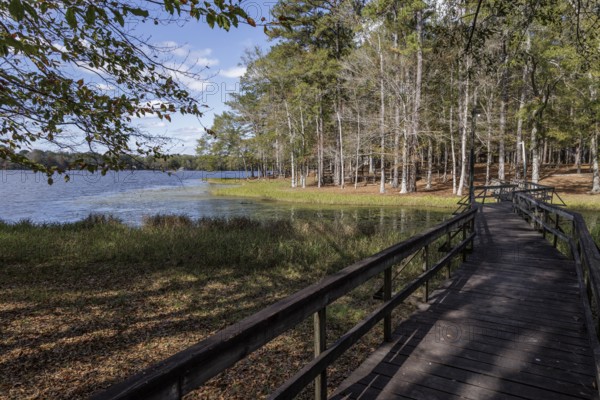Wooden pedestrian bridge over part of Archusa Creek Lake at Archusa Creek Water Park near Quitman, Mississippi