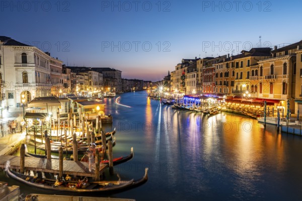 View of the Grand Canal at the blue hour, picturesque evening mood with illuminated palazzos on the canal, long exposure, view from the Rialto Bridge, Venice, Veneto, Italy