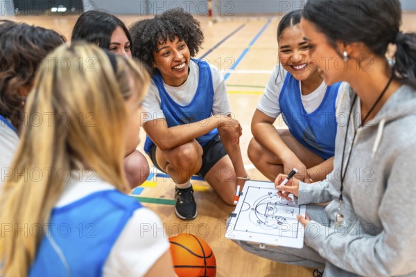 Female basketball coach drawing a play on a clipboard while explaining game strategy to her team during a time out