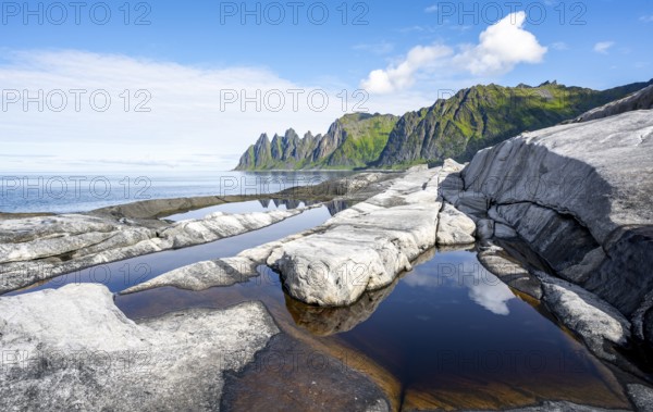 Reflection in a tidal pool, rocky coast of Tungeneset, Devil's Teeth, Okshornan, Ersfjorden, Senja Island, Troms, Norway