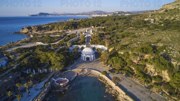 Drone shot, morning light, aerial view with domed building in green coastal landscape on the blue sea, Kalithea, Kallithea, thermal baths, spa, Rhodes, Dodecanese, Greek Islands, Greece