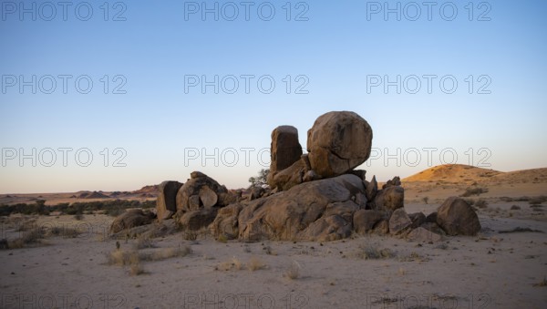 Round stacked rocks, desert landscape at sunset, Erongo, Damaraland, Namibia