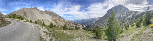 Panoramic view with left last bend of southern ramp southern ascent descent mountain road alpine road in front of pass summit of alpine pass pass road Col d'Izoard, Col de l'Izoard, Cottian Alps, Route des Grandes Alpes, Département Hautes-Alpes, France