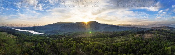 Panorama of Sunset over Mountains and Coniston Water from drone, Lake District National Park, Cumbria, England, United Kingdom