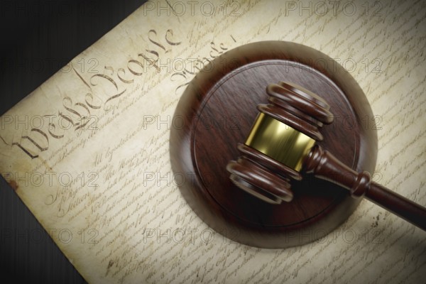 United states constitution and gavel resting on table