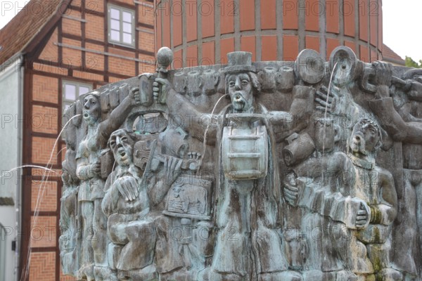 Fountain Mr Pastor sien Kauh Stephan Horota 1979 with bull figure, homage to Low German folk song, detail, joy, celebrate, cheerful, make music, sing, violin, drum, gargoyle, water jets, modern art, bronze sculpture, bell, gargoyle, water jets, Schlachtermarkt, Schwerin, Mecklenburg-Vorpommern, Germany