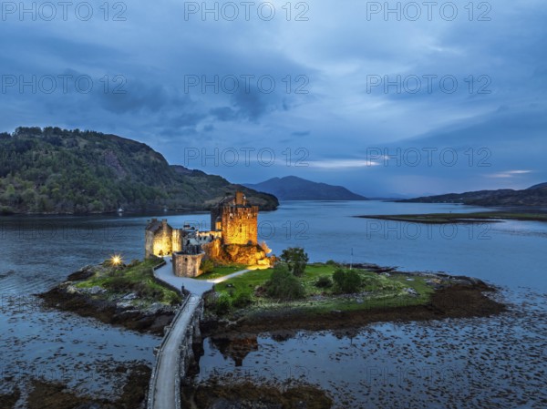 Night over Eilean Donan Castle and Loch Duich from a drone, Isle of Skye, Highlands, Scotland, England, United Kingdom