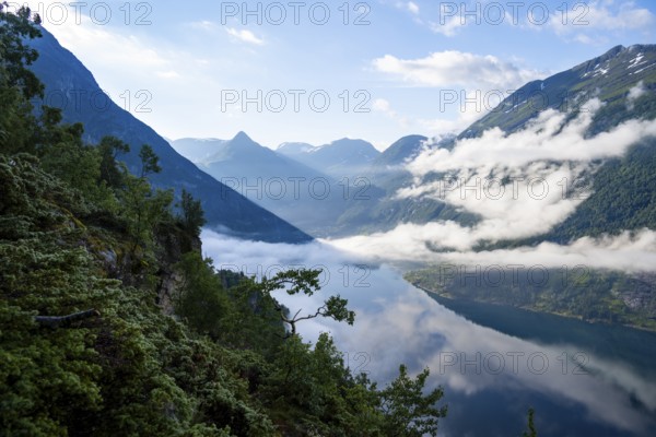 View over the Geirangerfjord, atmospheric clouds over the fjord in the morning light, Ørnesvingen viewpoint, near Geiranger, Møre og Romsdal, Norway