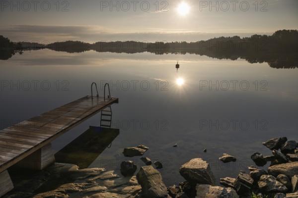 Wooden jetty with ladder, calm water surface, morning atmosphere, Kasnäsintie, Falkö Fjord, Kasnäs, Hitis archipelago, archipelago south of Turku, Finland