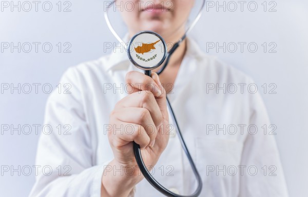 Female doctor holding stethoscope with Chipre flag. National health system of Chipre