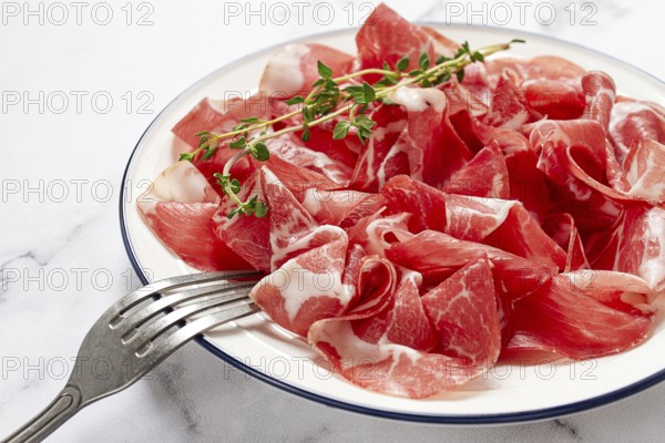 Plate with sliced cured meat, pork neck, prosciutto coppa, Italian delicacy