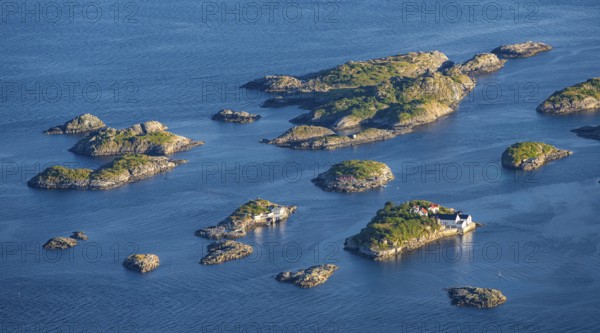 Small rocky islands with individual houses in the sea, archipelago islands, near Henningsvær, Vågan, Lofoten, Nordland, Norway