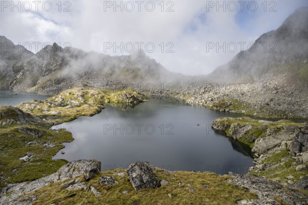 Mountain lakes Wangenitzsee and Kreuzsee, cloudy mountain peaks in the morning, Schober group, Hohe Tauern National Park, Carinthia, Austria