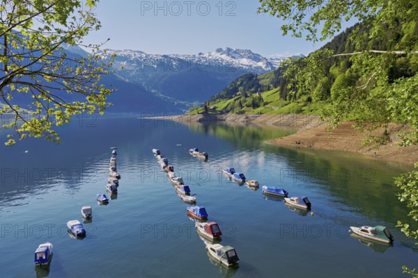 Motorboats moored at the reservoir, snow-covered Alps in the background, Lake Wägital, Canton Schwyz, Switzerland