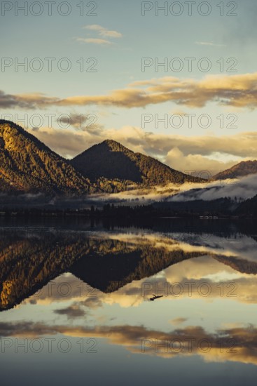 Sunrise with reflections and alpenglow in Lake Heiterwanger See in Tyrol in the Alps in Austria