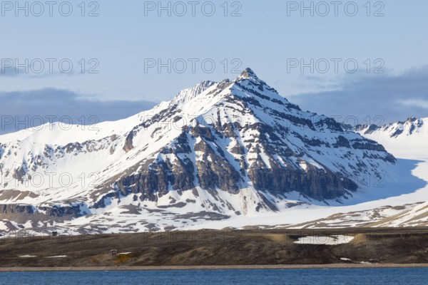 Mountain peaks, sedimentary rocks, snow, sea, Spitsbergen, Svalbard