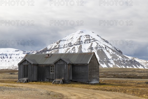 Wooden house against a mountain backdrop, Ny-Alesund, Spitsbergen, Svalbard