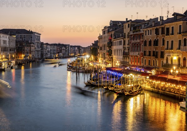 View of the Grand Canal at the blue hour, picturesque evening mood with illuminated palazzos on the canal, long exposure, view from the Rialto Bridge, Venice, Veneto, Italy