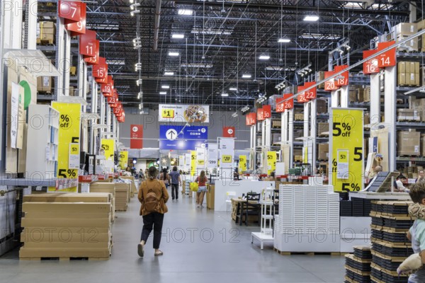 Customers shopping in the warehouse section of IKEA home store
