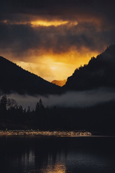 Surreal light atmosphere at sunrise at Plansee, Tyrol, in the Alps in Austria