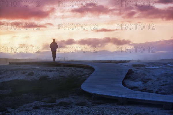 Lone walker on wooden path, sulphur vapour, Hveravellir geothermal area, sunset, illustration, Icelandic highlands, Suðurland, Sudurland, Iceland