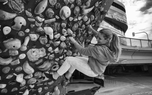 Woman, blonde, 40 years, climbing on climbing wall, urban, concrete, black and white, Stuttgart, Baden-Württemberg, Germany