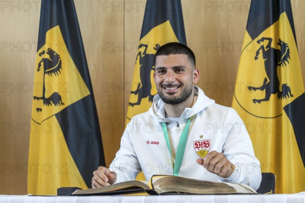 Deniz Undav signing the Golden Book of the City of Stuttgart. Reception organised by the state capital Stuttgart after VfB Stuttgart's victory in the DFB Cup. Stuttgart, Baden-Württemberg, Germany