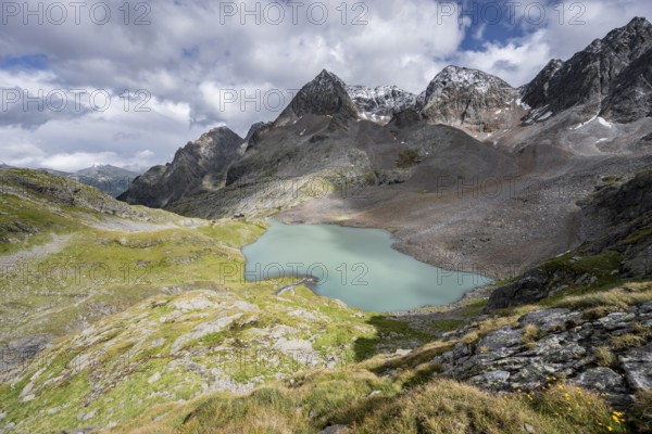 View of the turquoise-blue mountain lake Großer Gradensee, with the peaks of Petzeck and Kruckelkopf behind, Schober Group, Hohe Tauern National Park, Carinthia, Austria