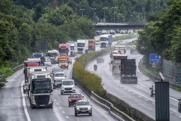 Heavy traffic, mainly lorries, on the A40 motorway near Rheurdt, at the Neufelder Heide rest area, a few kilometres in front of the border with the Netherlands, rainy weather, North Rhine-Westphalia, Germany
